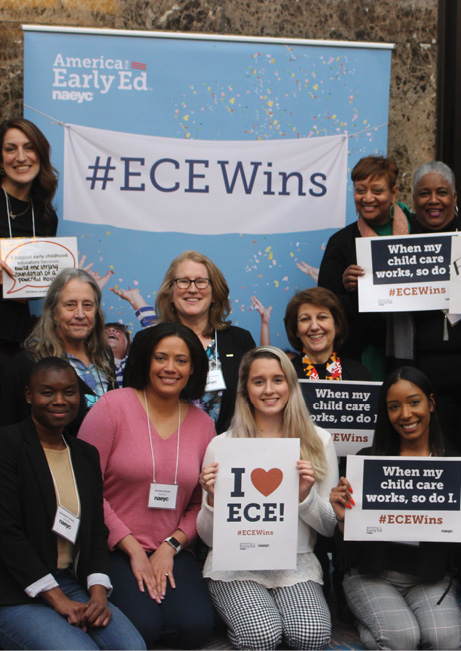 photo of NAEYC members in front of the America for Early Ed poster holding up signs in support of ECE